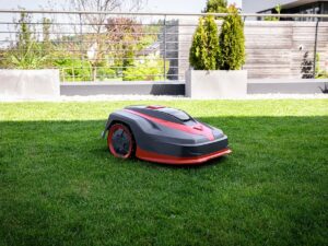 A robotic lawn mower on a green, well-maintained lawn.